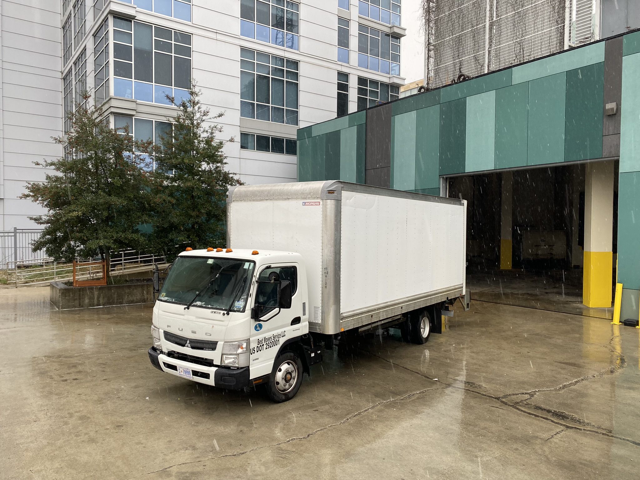 Moving team carrying boxes and furniture